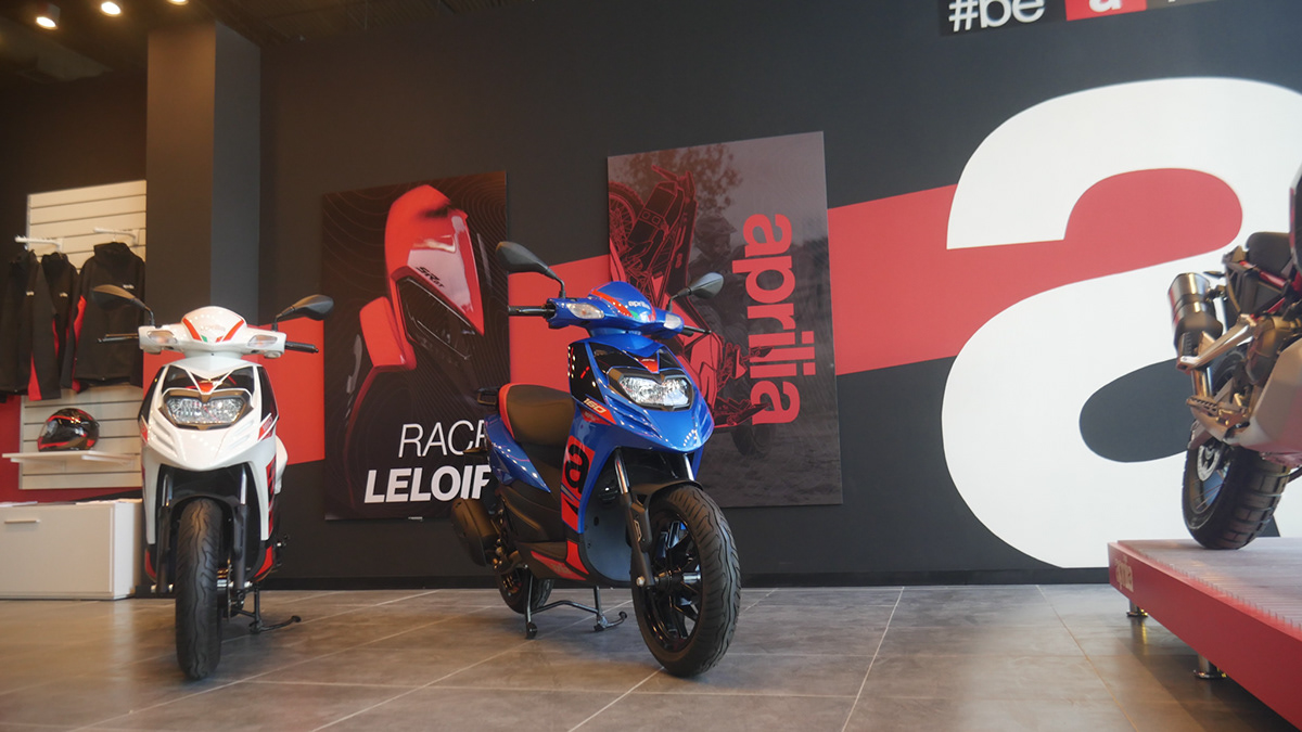 Aprilia showroom with RACE LELOIR poster